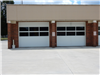 A brick building with garage doors on it.