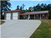 A large brick building with white garage doors.