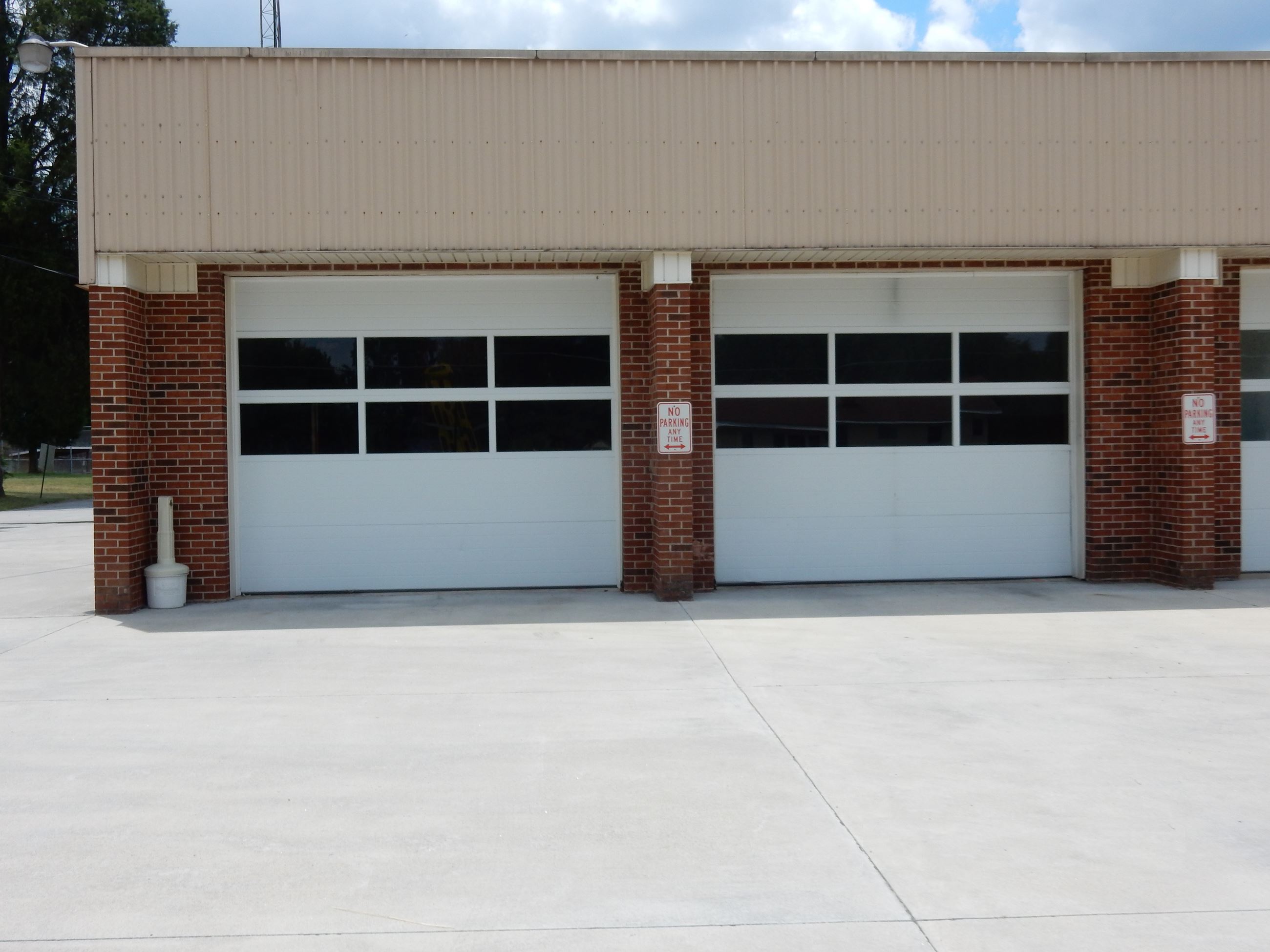 A brick building with garage doors on it.
