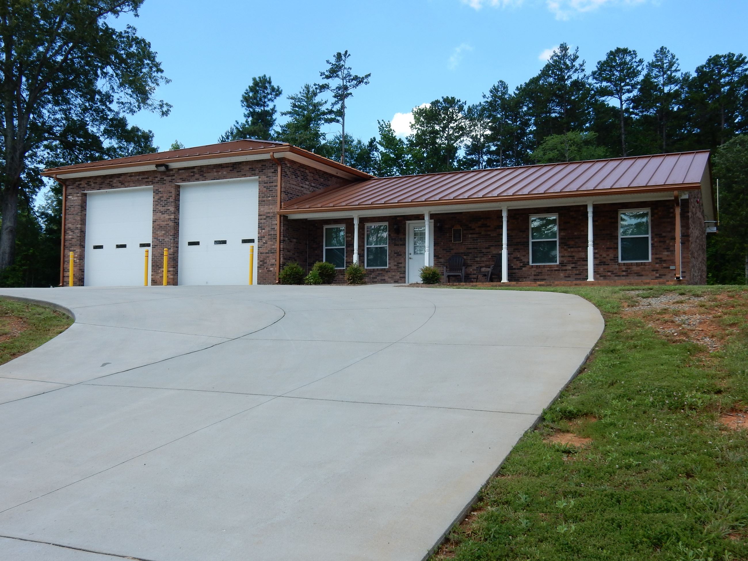 A large brick building with white garage doors.