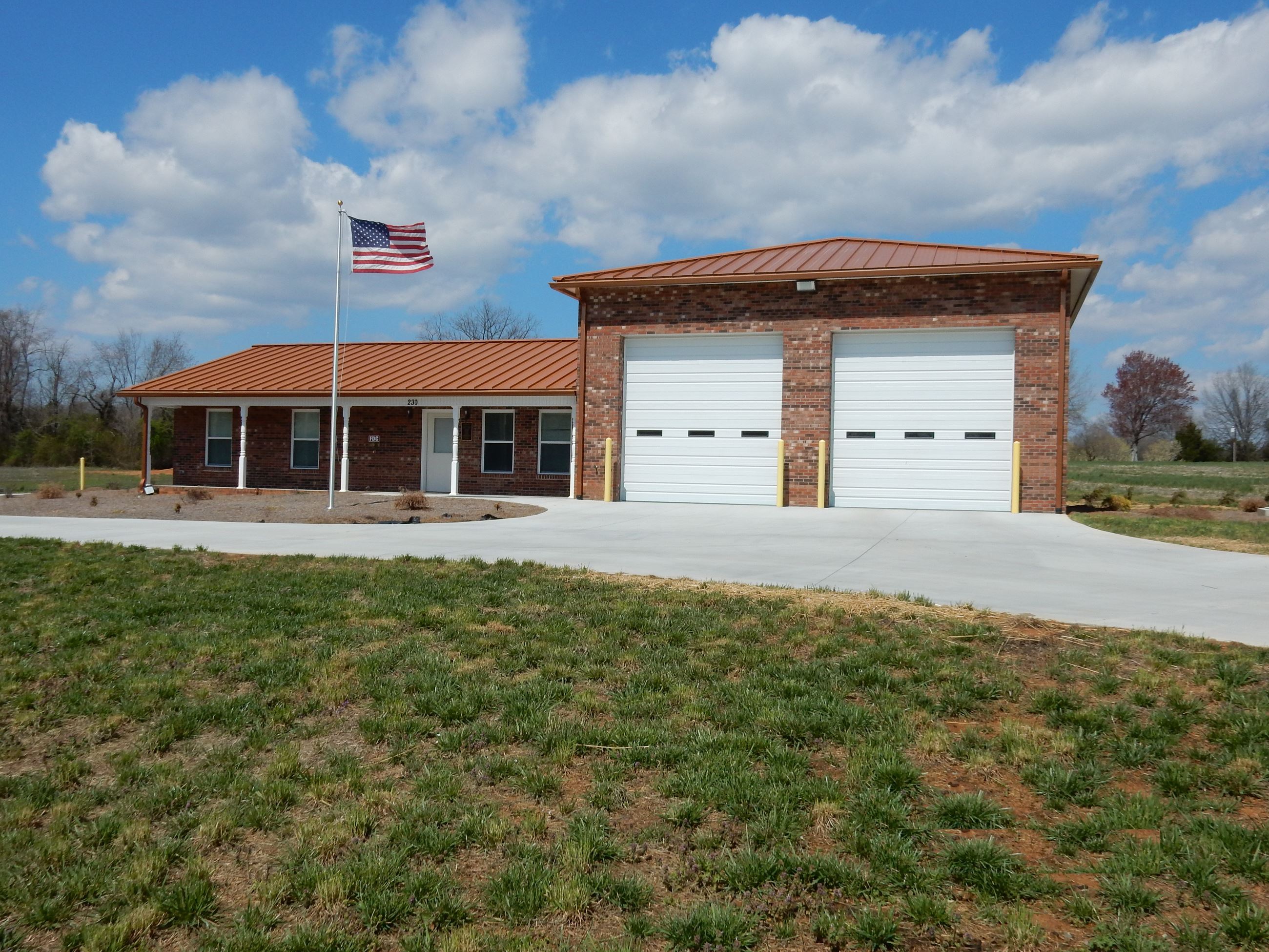 A large brick building with white garage doors.