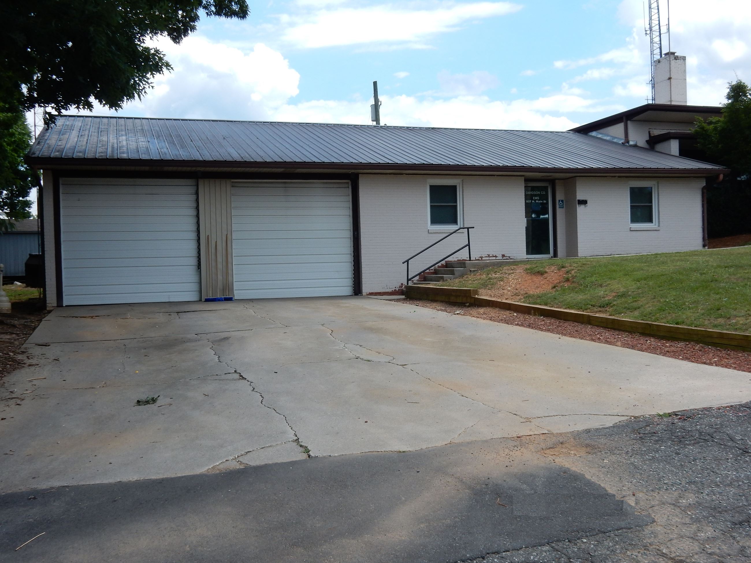 A white building with two white garage doors.