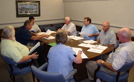 Soil and Water Conservation District board members gathered around a table during a board meeting